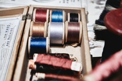 A vintage wooden box of thread spools.